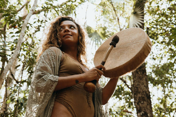 istock One multiracial woman practicing sound healing ceremony in the rainforest 1387524728