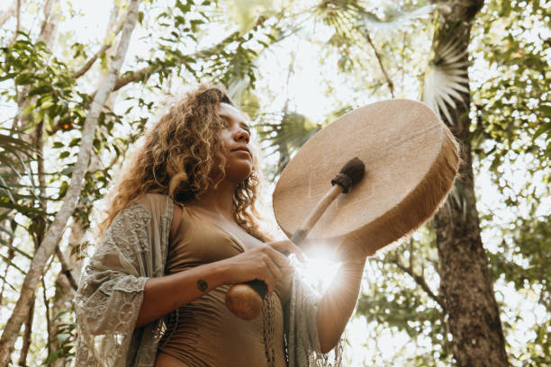 istock One multiracial woman practicing sound healing ceremony in the rainforest 1387524953