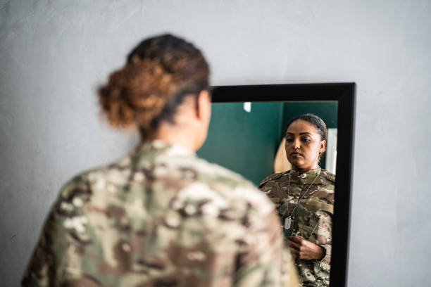 istock Female soldier getting ready ready to leave at home 1387528230