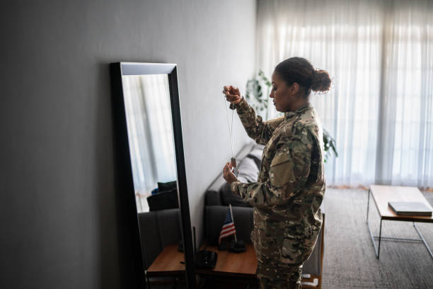 istock Female soldier getting ready ready to leave at home 1387528237