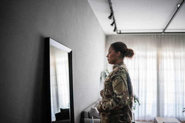 istock Female soldier getting ready ready to leave at home 1387528238