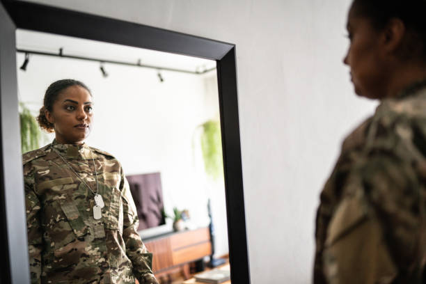 istock Female soldier getting ready ready to leave at home 1387528250