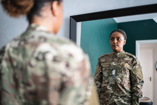 istock Female soldier getting ready ready to leave at home 1387528256