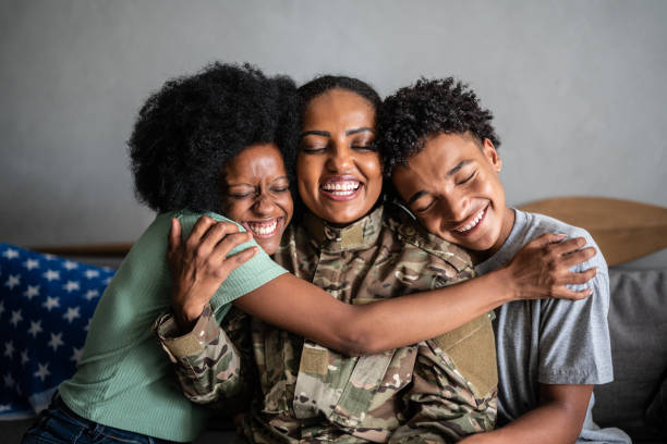 soldier mother embracing son and daughter at home - homecoming imagens e fotografias de stock