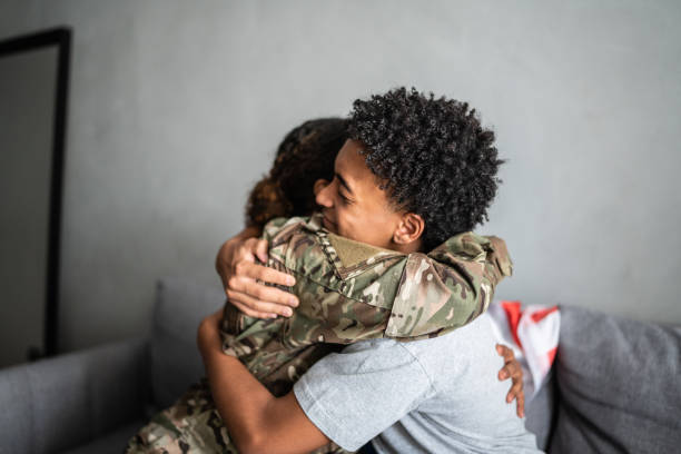 istock Soldier mother and son hugging each other at home 1387528365