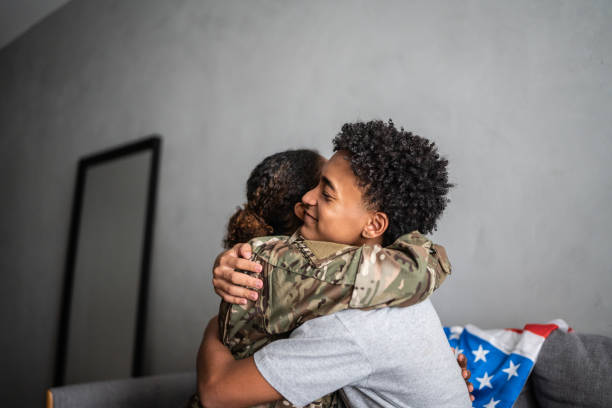 istock Soldier mother and son hugging each other at home 1387528372