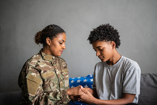 Soldier mother saying good bye to her son at home