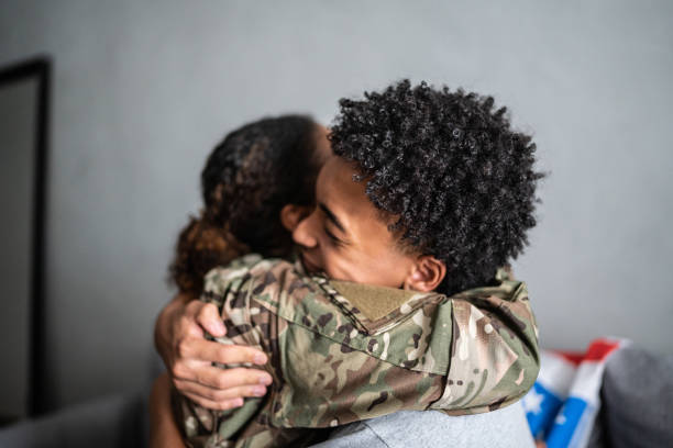istock Soldier mother and son hugging each other at home 1387528383