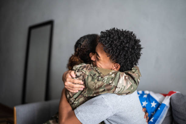 istock Soldier mother and son hugging each other at home 1387528399