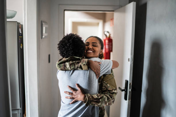 Son welcoming soldier mother at home
