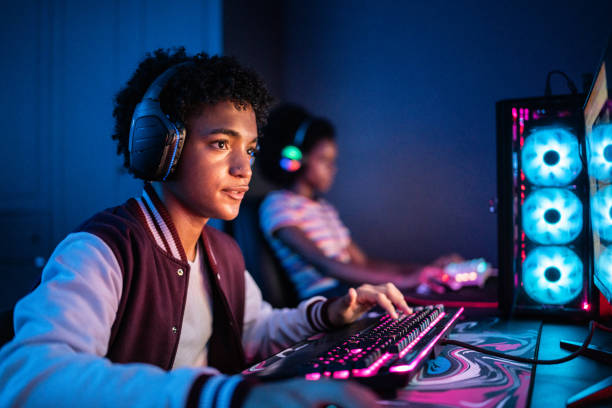 istock Teenage boy playing on the computer at home 1387529280