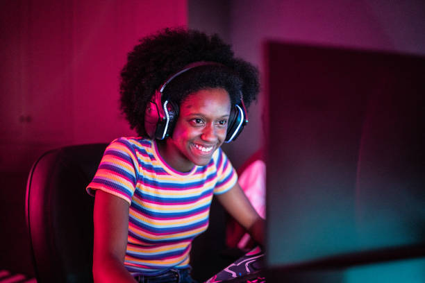 istock Young woman playing on the computer at home 1387529484