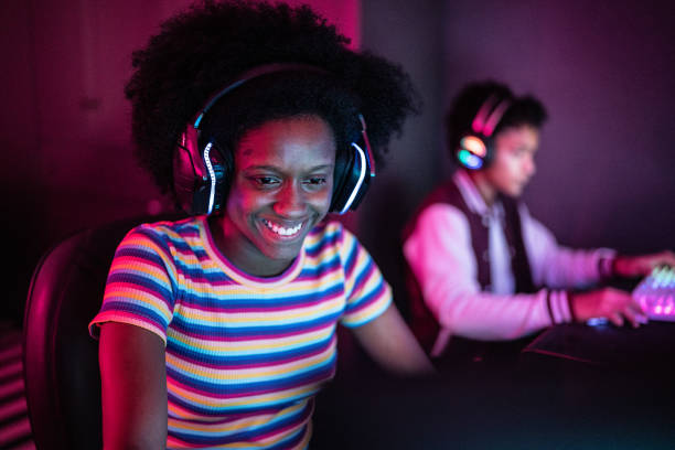 istock Young woman playing on the computer at home 1387529501