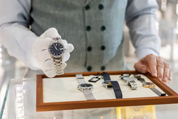 Senior man in jewelry store selling luxury watches