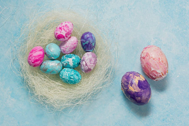 istock Happy Easter. Easter colorful eggs on a mint wooden background. 1387531041