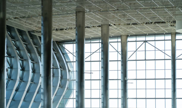 istock Ceiling at airport - modern architecture. Metal roof frame with metallic columns, lighting and ventilation systems of modern mall building 1387531083