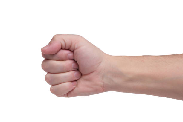 istock Man hand is launched into fist, isolated white background. 1387531684