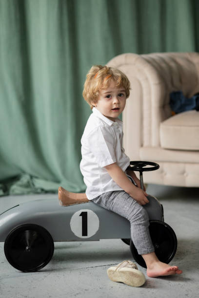 istock Little boy driving big toy car 1387531903