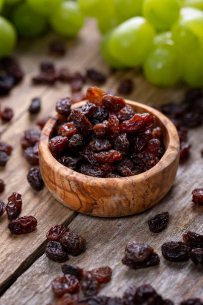 istock Raisins and grapes - wooden bowl 1387532120