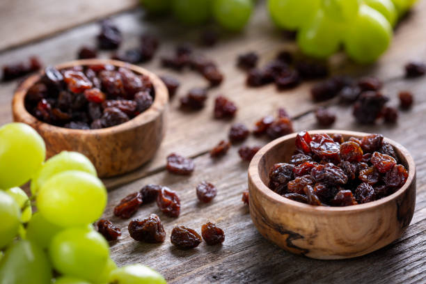istock Raisins and grapes - wooden bowl 1387532210
