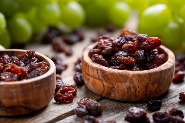 istock Raisins and grapes - wooden bowl 1387532628