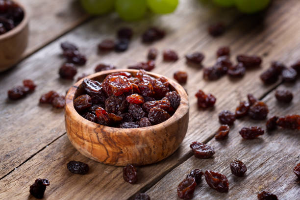 istock Raisins and grapes - wooden bowl 1387532633