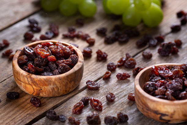 istock Raisins and grapes - wooden bowl 1387532635