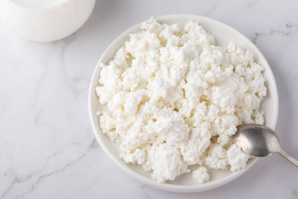 istock Bowl with fresh cottage cheese on white table 1387533283