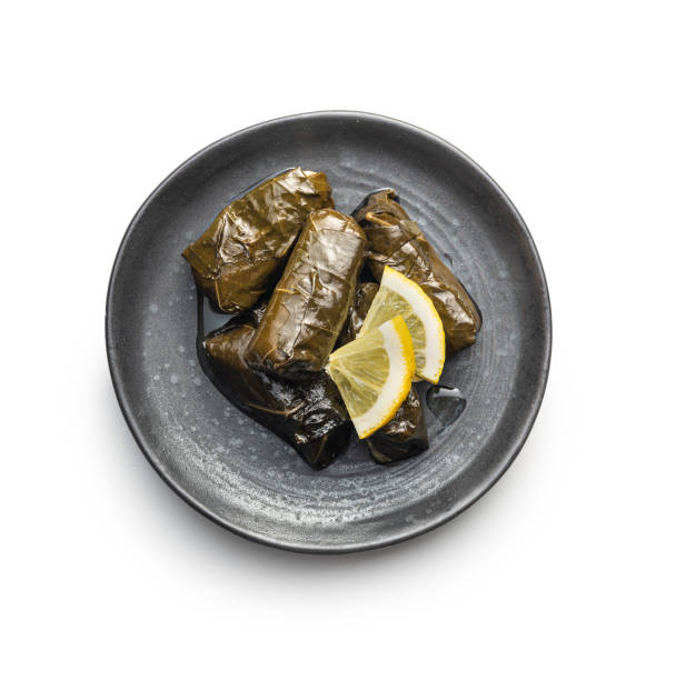 istock Dolmades. Stuffed vine leaves. Greek appetizer isolated on white background. 1387536294