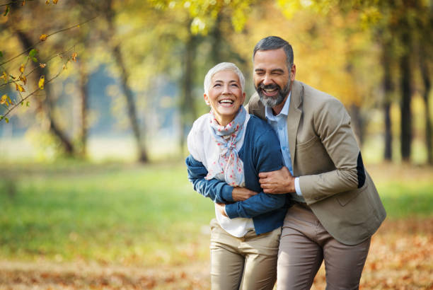 istock Mature couple walking through a park. 1387537857