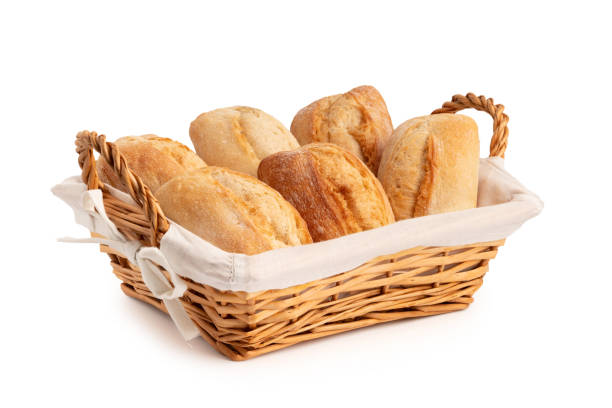 istock Fresh wheat buns in a wicker basket isolated on white 1387541356