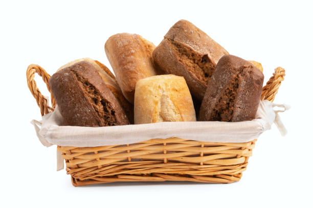 istock Fresh wheat and rye bread in a wicker basket isolated on a white background 1387541365