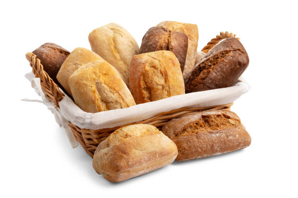 istock Freshly baked wheat and rye breads in a wicker basket isolated on a white background. 1387541366