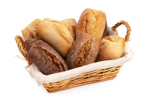 istock Fresh wheat and rye bread in a wicker basket isolated on a white background 1387541380