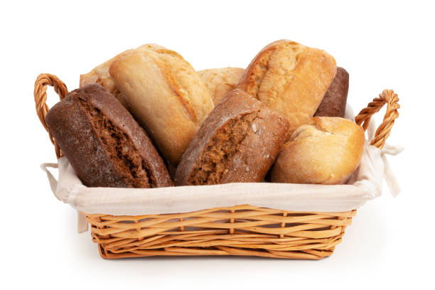 istock Fresh wheat and rye bread in a wicker basket isolated on a white background 1387541393
