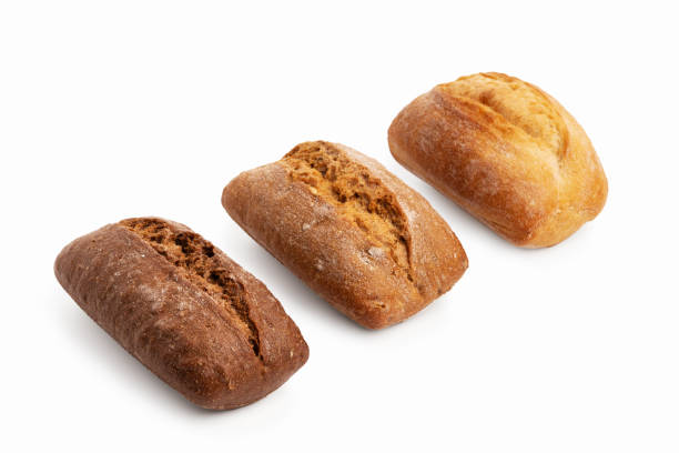 istock Three freshly baked buns of different sorts wheat and rye isolated on white 1387541442
