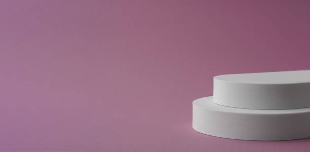 istock Panorama of white round podium on pink background with copy space 1387548583