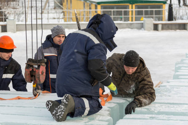 istock Installers unloading ice blocks for an ice town 1387549223