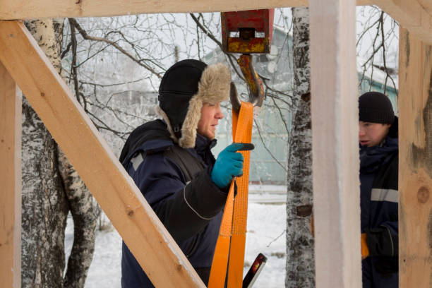 istock Workers assembling the frame of a wooden slide 1387549531