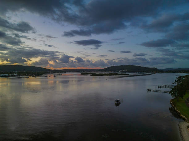 istock Sunrise and rain clouds waterscape 1387550509