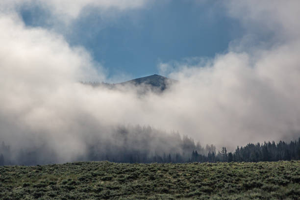 istock Mountain peak with the fog lifting 1387555313