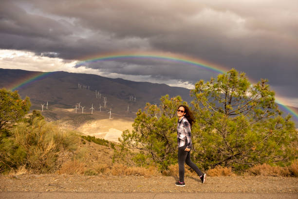 Woman of about 40 years happy to contemplate rainbow.