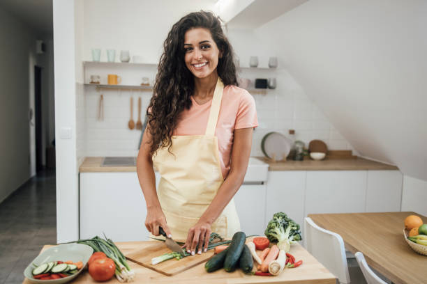 istock Beautiful vegan making a fresh meal 1387557189
