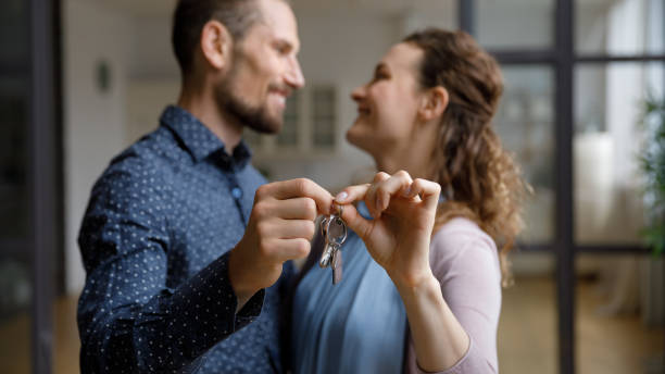 istock Happy cheerful young couple moving into new home 1387557310