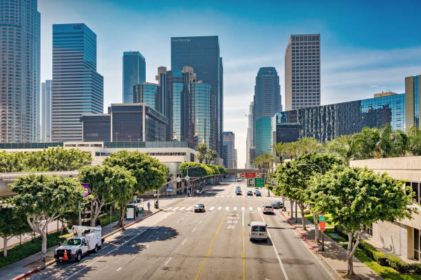 Cars drive on Figuerora Drive in downtown Los Angeles California USA on a sunny day.