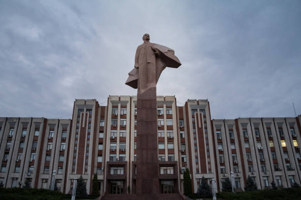 Transnistria Parliament building in Tiraspol with a statue of Vladimir Lenin in front. Transnistria is an urecognized breakaway republic in Moldova. Picture of the Lenin statue in front of the parliament of Transnistria in Tiraspol. Transnistria (also called Trans-Dniestr or Transdniestria) is a small breakaway state located between Moldova and Ukraine. Unlike Moldova, following the dissolution of the USSR the de facto sovereign state of Pridnestrovia chose not to separate from the Russian Federation and this escalated into a military conflict with Moldova in March 1992. A ceasefire was concluded in July 1992 and Transnistria is now an unrecognized independent presidential republic with its own government, parliament, military, police, postal system, and currency. vladimir lenin photos stock pictures, royalty-free photos & images