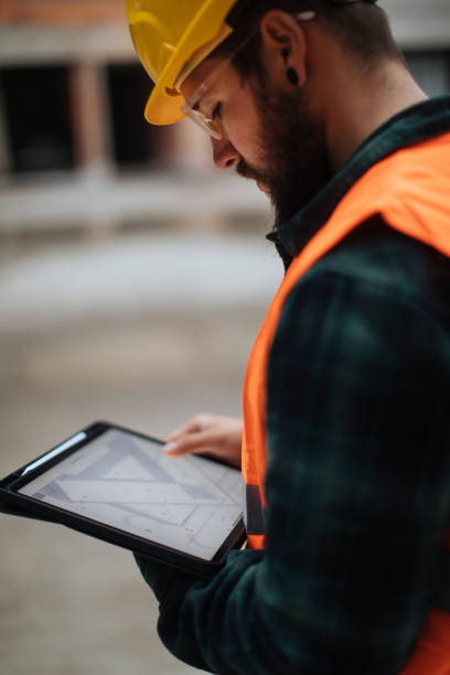 making paper blueprints a thing of the past - manual worker portrait helmet technology imagens e fotografias de stock