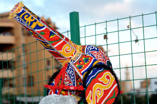 A decorative Ramadan breakfast cannon covered with Kheyameya and Ramadan decoration on a blurred background of a cloudy sky in the street as a celebration of fasting month for Muslims, selective focus
