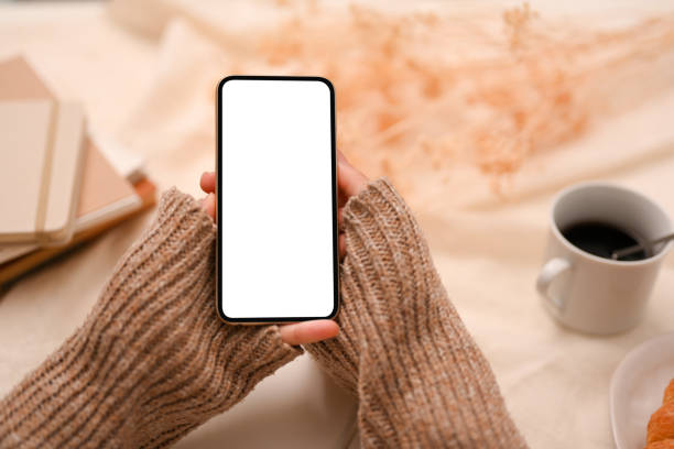 istock A smartphone white screen mockup on a women's hands 1387570264