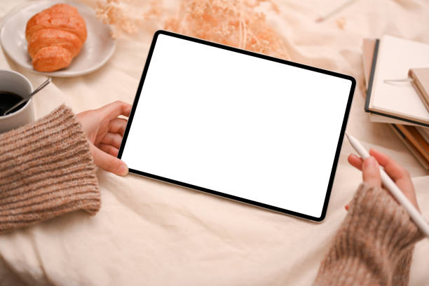 istock Young woman using digital tablet touchpad, reading something on website 1387570302
